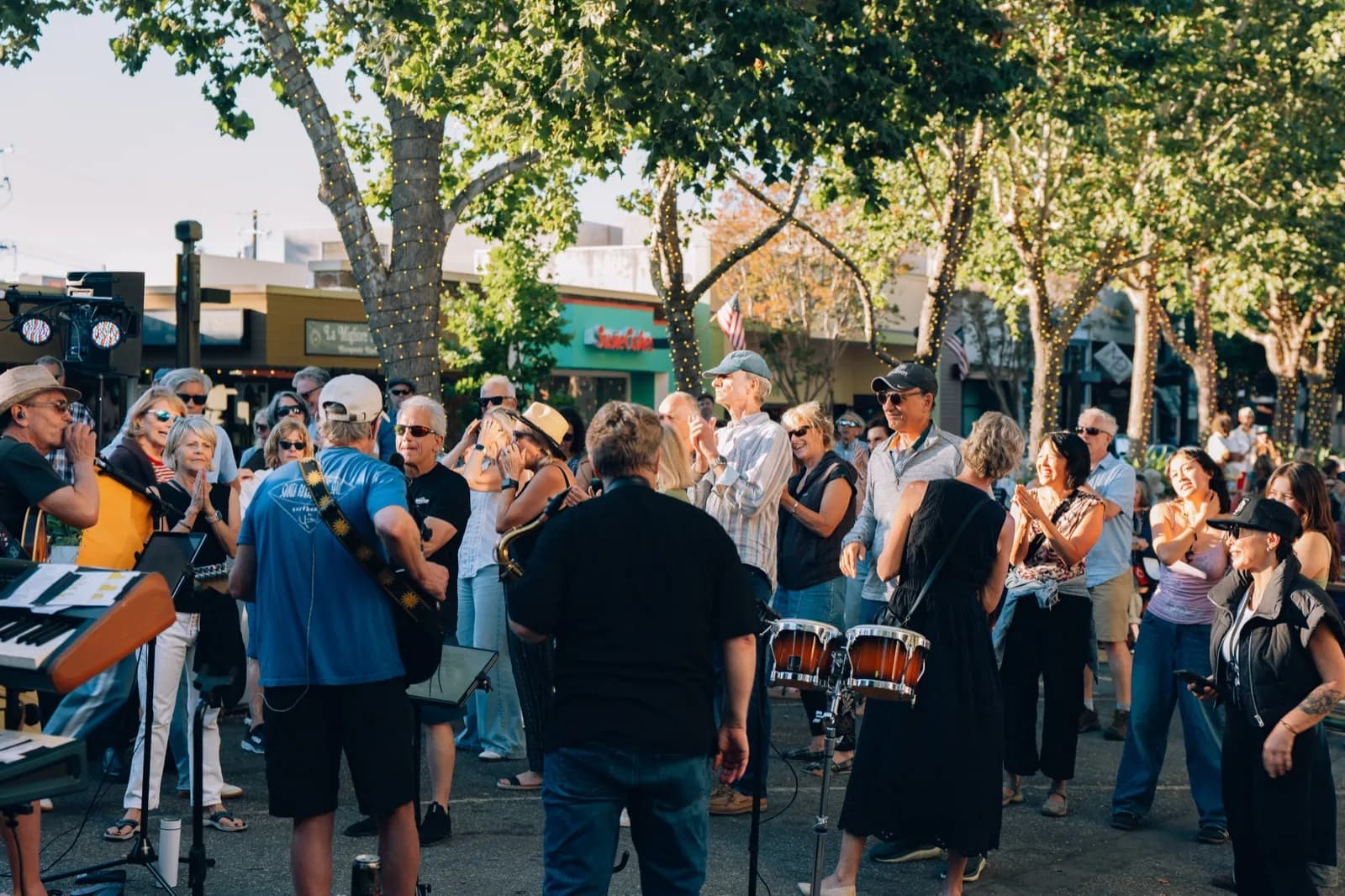 Crowd filling Santa Cruz Avenue under the trees at Fourth Fridays
